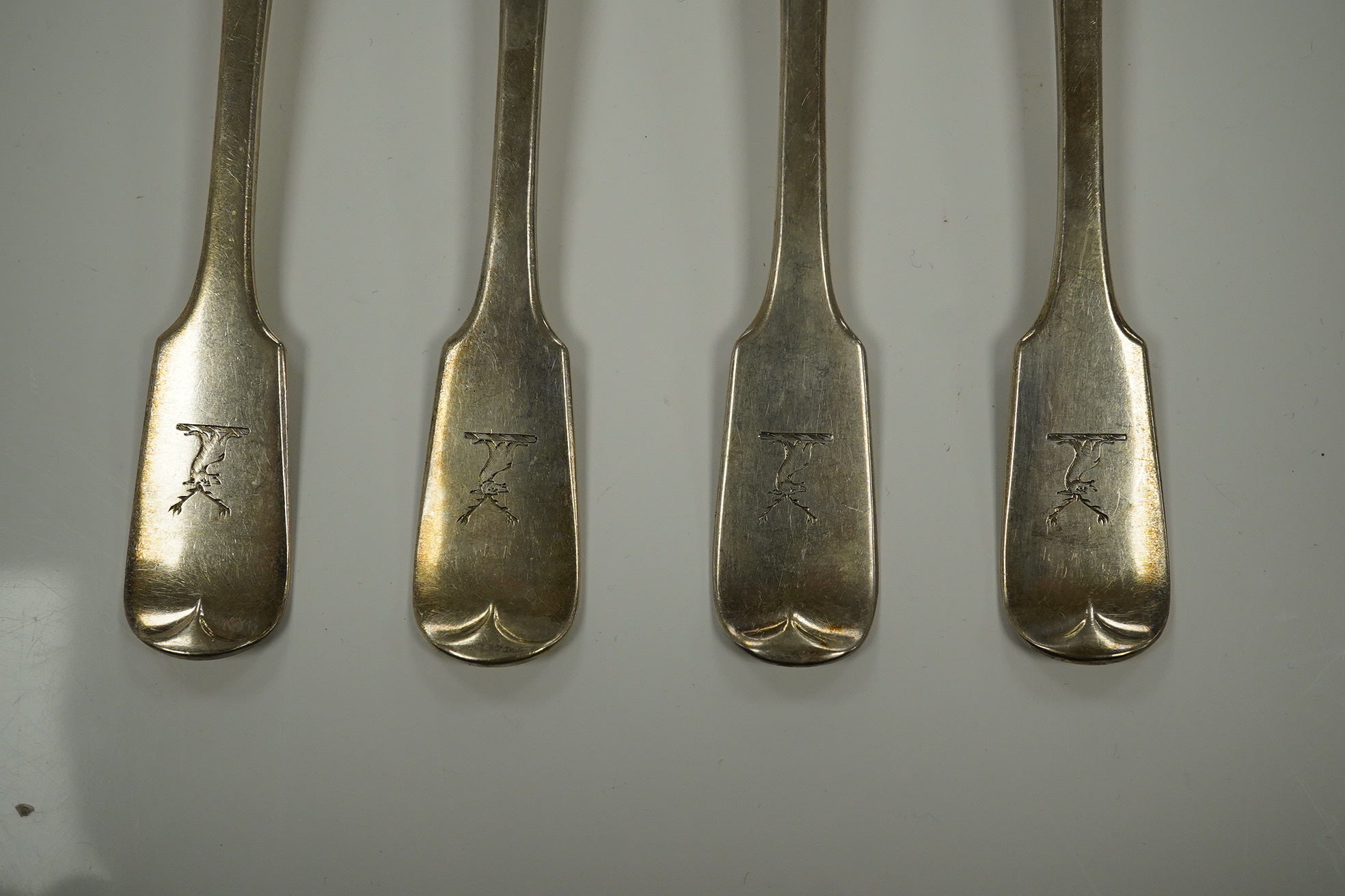 Eleven mainly 19th century silver fiddle pattern table forks, various dates and makers, 25.4oz. Condition - poor to fair